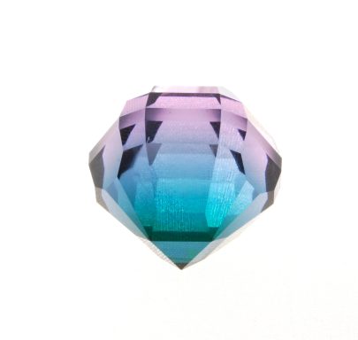 Faceted glass — Diggerglass A loose faceted manufactured-glass gem on a white background